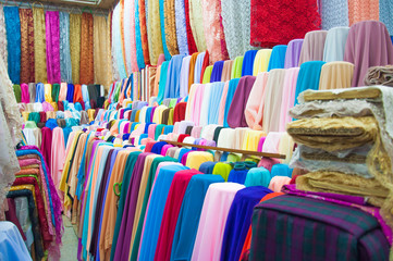 many reels of textile in the market, colorful, background