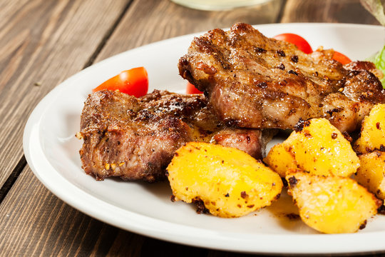 Grilled steaks, baked potatoes and vegetables