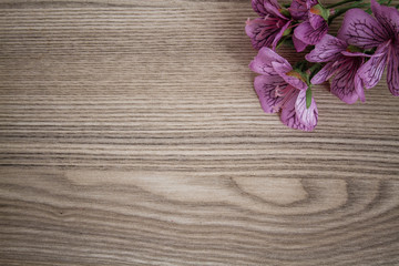 Obraz na płótnie Canvas Articial Flowers on Wooden Desk