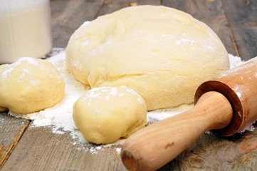 rolling pin and dough on a wooden table