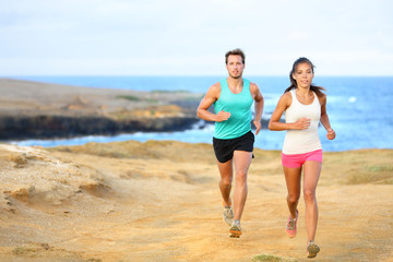 Sports couple jogging for fitness running outside