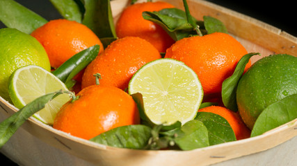 Mandarins and limes with leaves just from the tree