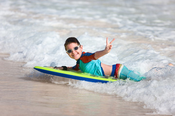 Boy swimming on boogie board