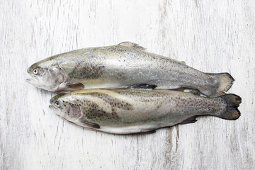 Two rainbow trouts on rustic wooden table