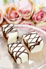 Chocolate and marzipan wedding cakes on glass cake stand. Bouque