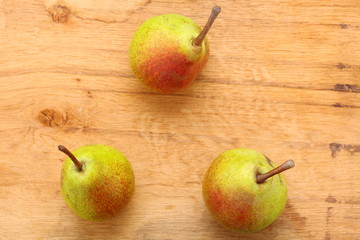 Three pears fruits on wooden table background