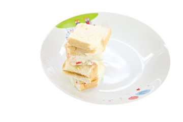 Bread sandwiches in White dish.