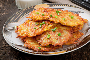 Fried potato pancakes on the old wooden background