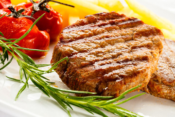 Grilled steak, French fries and vegetables