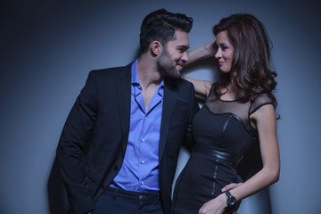 young couple laughs while looking at each other