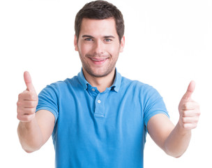 Fototapeta premium Young happy man with thumbs up sign in casuals