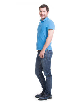 Full portrait of smiling happy handsome man in blue jeans.