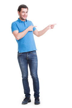 Young happy man shows a finger.