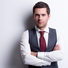 Portrait of young businessman in gray suit.
