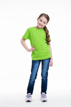 Smiling little girl in a green shirt.
