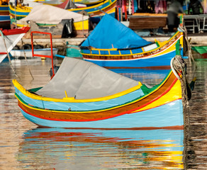 Fototapeta na wymiar Colored Fishing boats in Marsaxlokk harbor, Malta