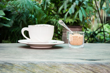 White cup of coffee and cane sugar