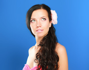 beautiful woman with flower over blue background.
