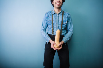 Happy young farmer holding a squash