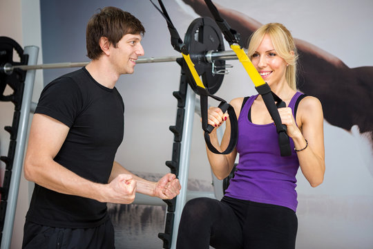 Personal trainer assist woman