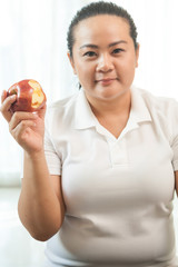 Fat woman with apple