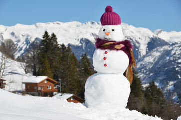 Snowman against Alpine panorama