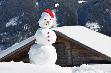 Snowman against Alpine panorama