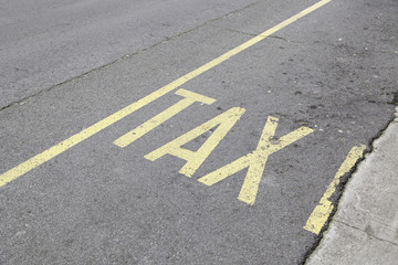 Taxi sign painted on asphalt