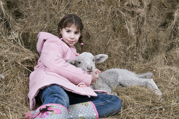 Girl with lamb lying