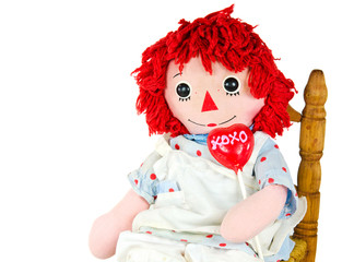 old rag doll with heart lollipop