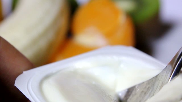 a person eats a yogurt
