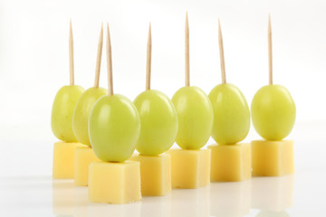 Appetizer - Grape with cheese on white background