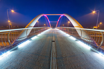 Foothpath bridge over bypass of Gdansk at night, Poland