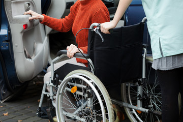 Caregiver helping get into the car