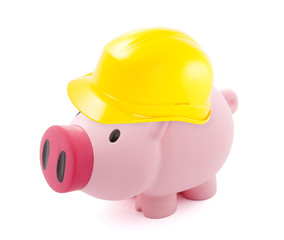 Fototapeta premium Piggy bank protected with hard hat isolated on white