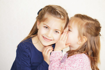 sister girls whisper in ear