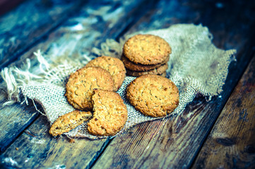 Vintage oatmeal cookies on rustic wooden background