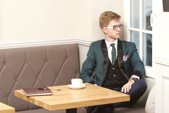 Young handsome stylish man in cafe with coffee
