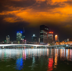 Fototapeta premium Brisbane skyline at night with river reflections