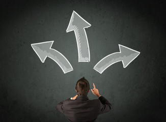 Businessman deciding with arrows above his head