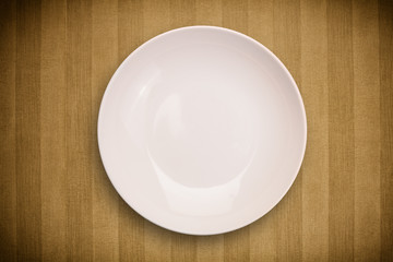 Colorful empty plate on grungy background table