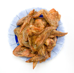 Fried chicken wings on a the plate isolated on white background