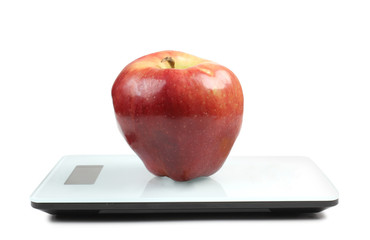 Red apple on scales