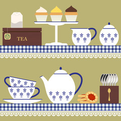 Tea set with teabag, cupcake and cookies