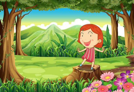 A smiling little girl standing above the stump
