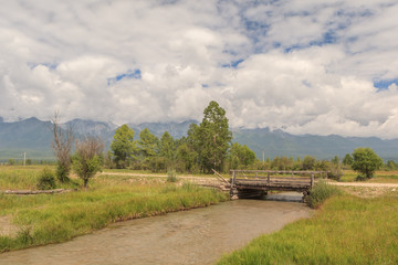 Fototapeta premium The bridge through the river in a mountain valley.