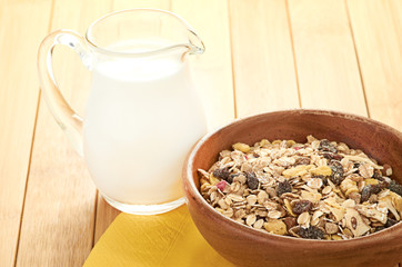 Plate with raw oatmeal on wooden table.
