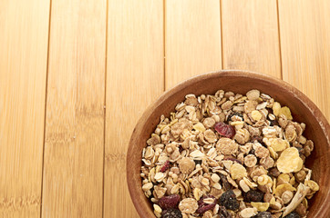 Plate with raw oatmeal on wooden table.