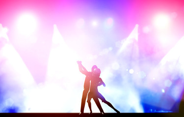 A couple of dancers in elegant, passionate dancing pose in club