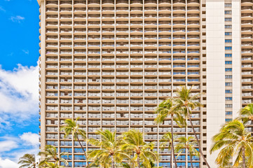 Waikiki hotel facade detail with palms in Honolulu